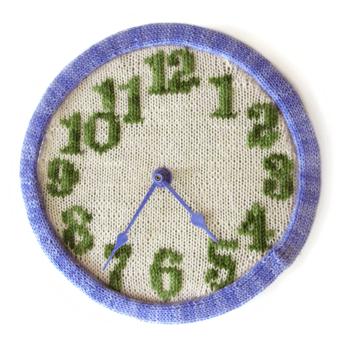 knitted clock pattern in purple, green, and neutral