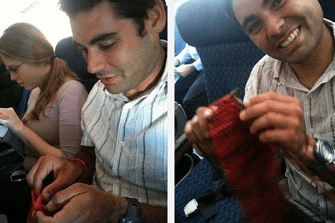 man knitting on plane and smiling