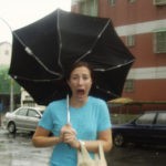 Funny photo of a woman with an inside-out umbrella