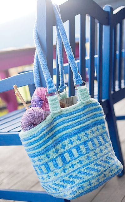 Fair-Isle felted bag shown hanging on bench