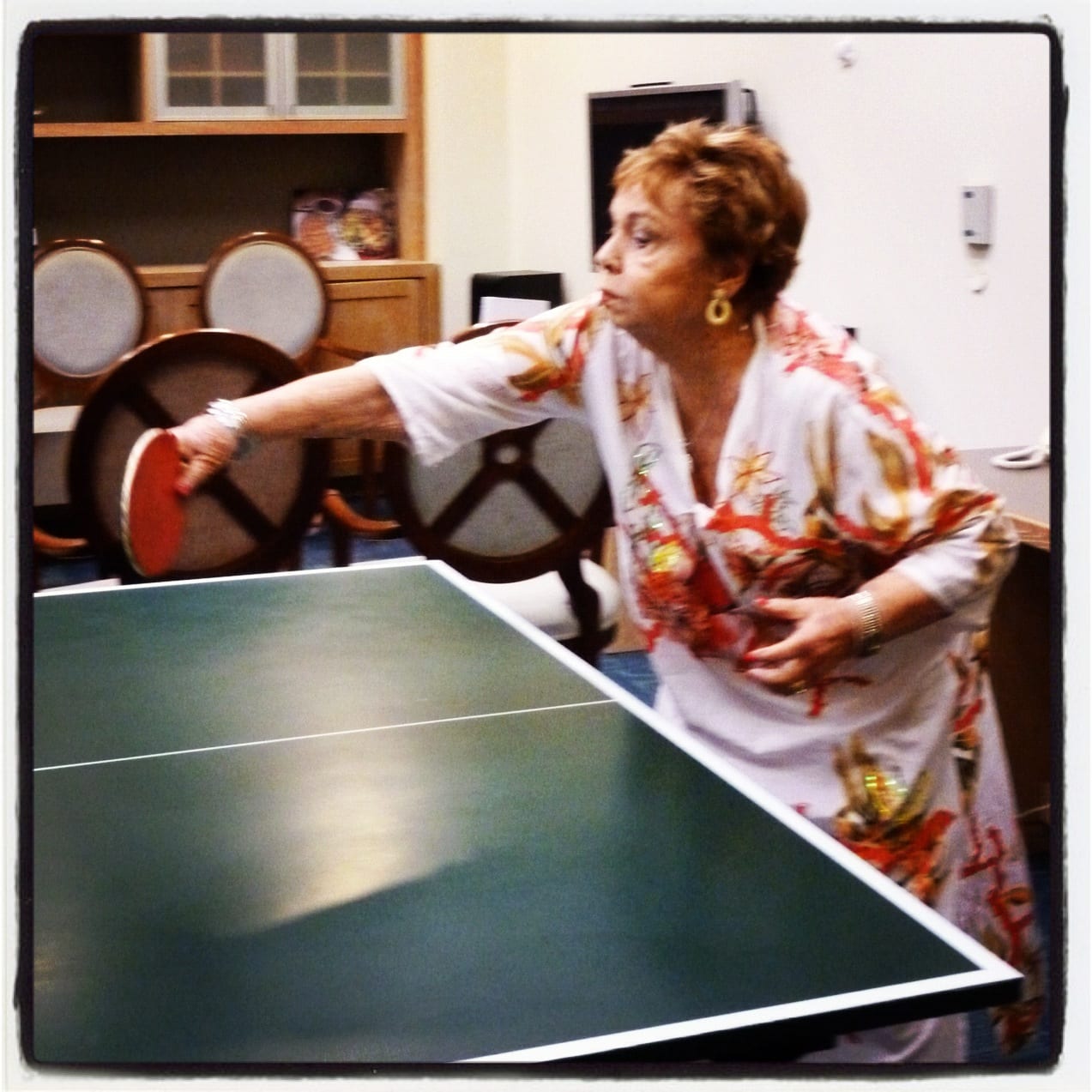 Liat's grandma playing ping pong in a mumu