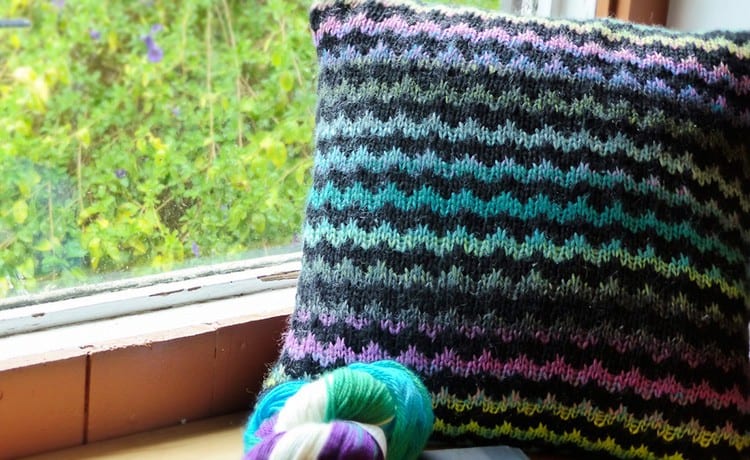 A zigzag striped pillow with a self-striping yarn