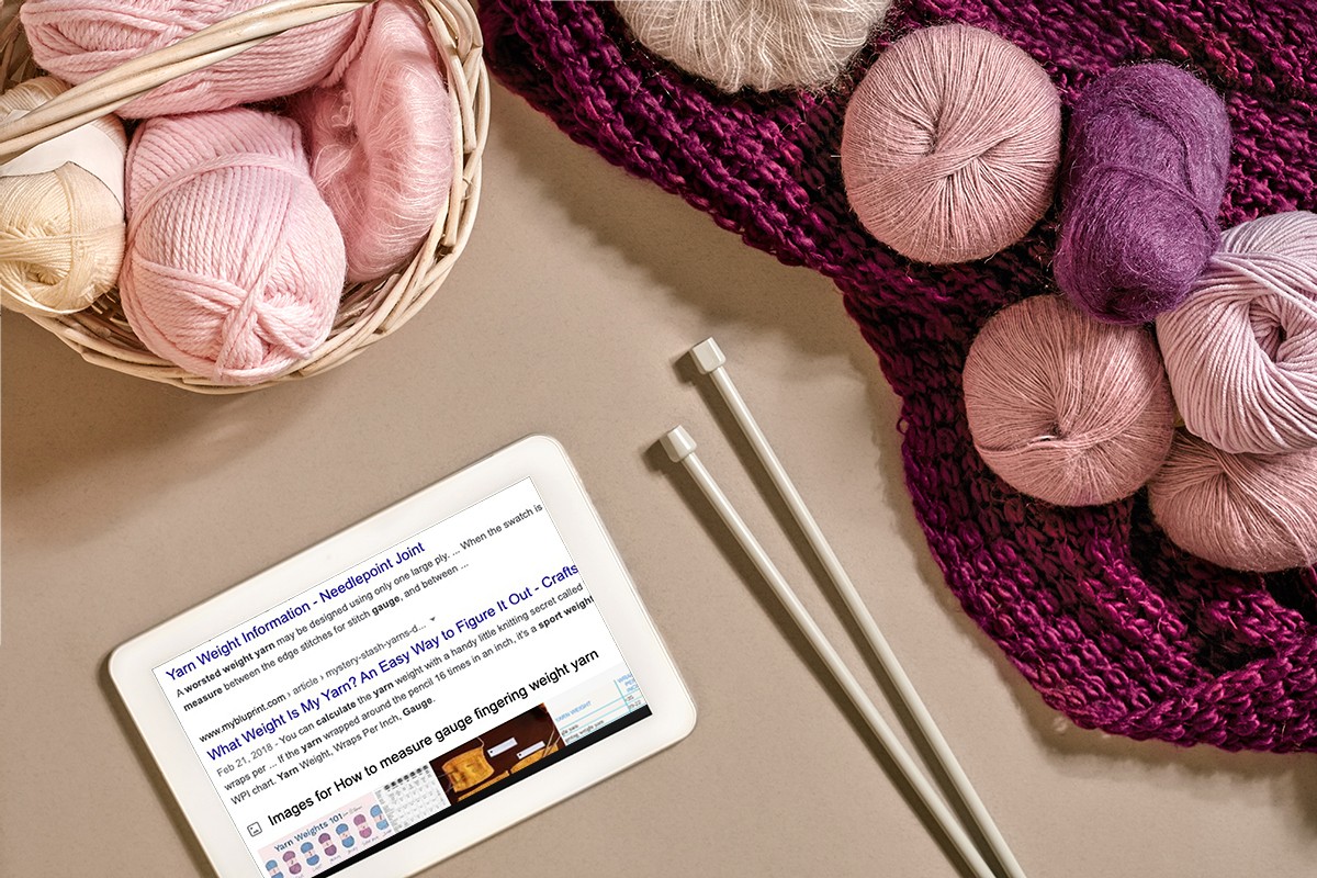 Yarn balls lying next to tablet composite image Google yarn results