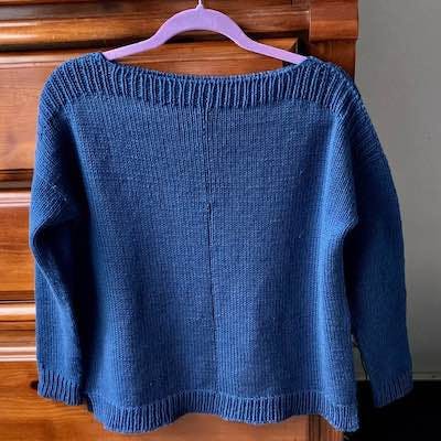 blue sweater on a hanger