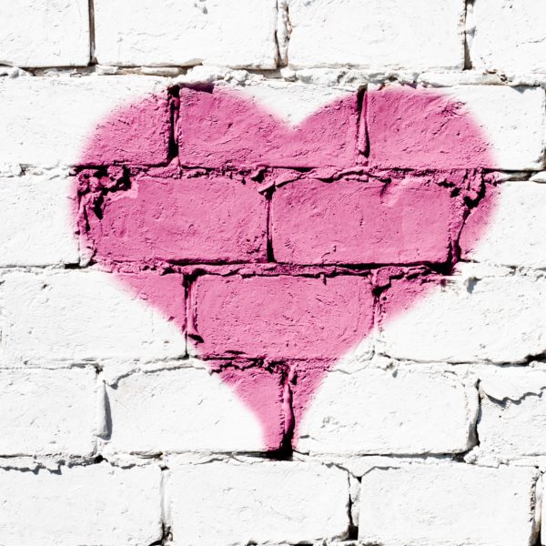 pink heart on white brick